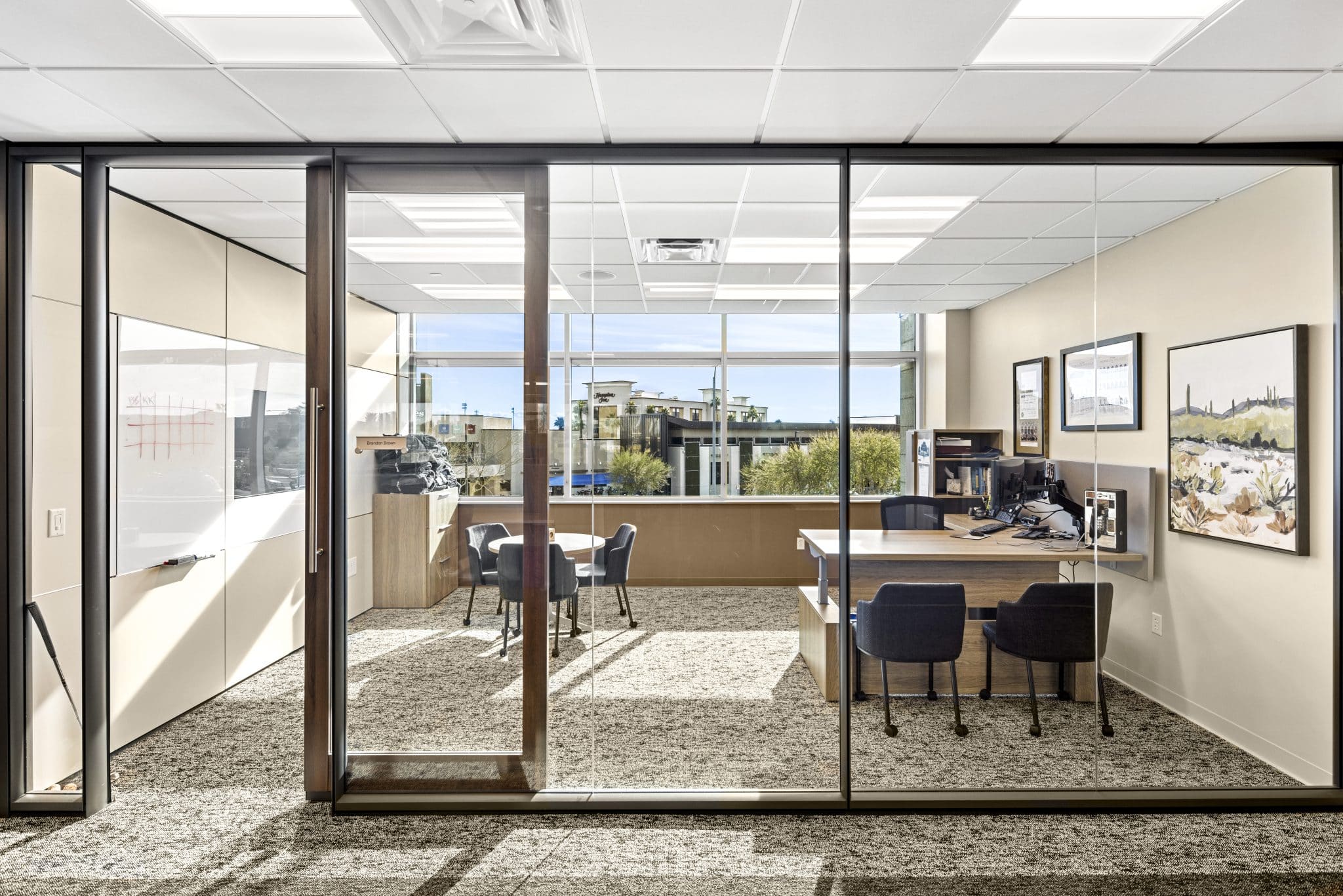 DIRTT and Kimball, closed office, table and chairs, sliding glass doors and glass walls. Whiteboard. Office furniture